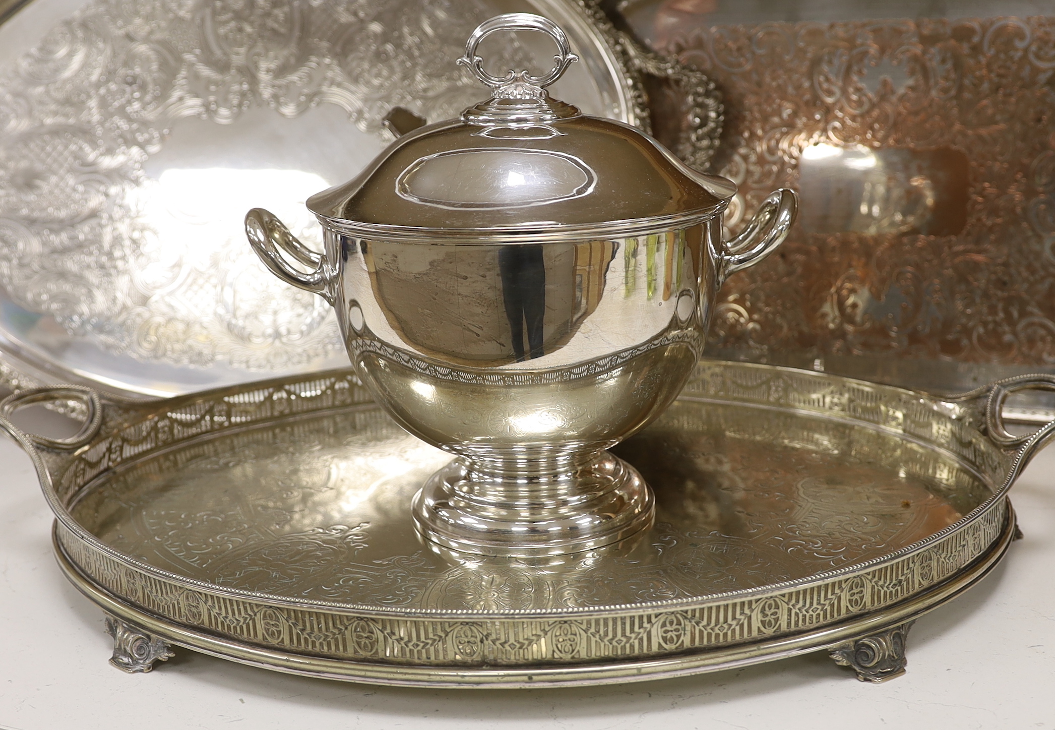 Four items of plated wares; a Victorian galleried tray, a soup tureen and two other trays, largest tray 67cm